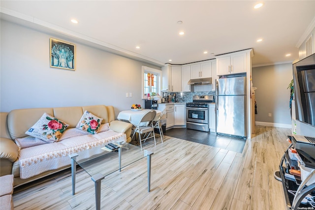 living room featuring light wood-type flooring and ornamental molding