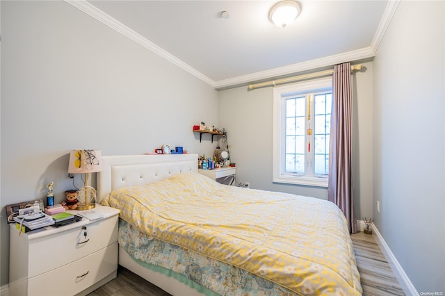 bedroom featuring hardwood / wood-style floors and ornamental molding