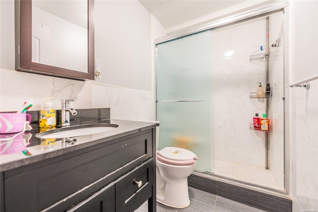 bathroom featuring vanity, an enclosed shower, tile walls, and toilet