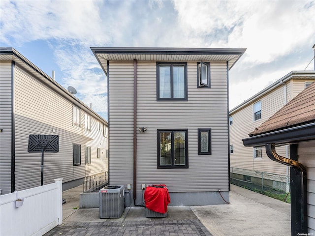 rear view of house featuring central AC and a patio area