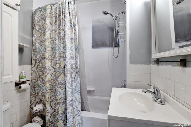 full bathroom with vanity, shower / bath combo, tile walls, and toilet