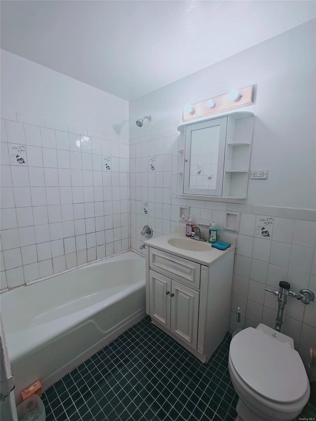 full bathroom featuring tile patterned floors, vanity, tile walls, toilet, and tiled shower / bath