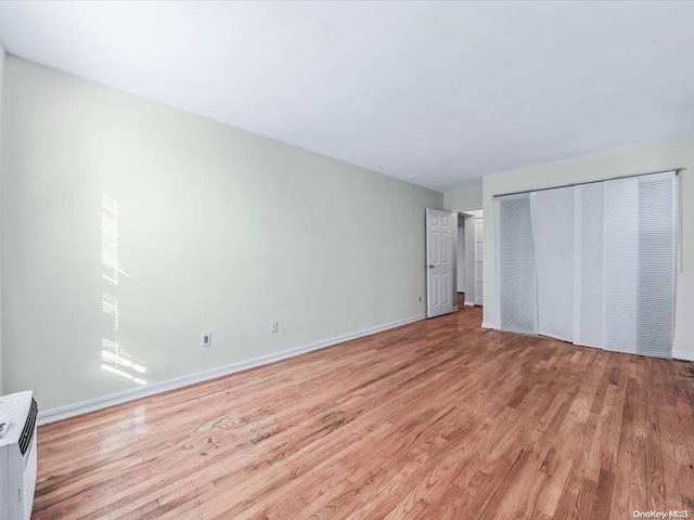 unfurnished bedroom featuring a closet and light hardwood / wood-style flooring