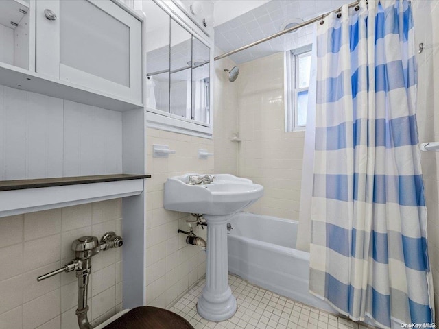 bathroom featuring tile patterned flooring, shower / bathtub combination with curtain, and tile walls