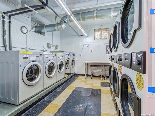 laundry room featuring washing machine and dryer and stacked washer / drying machine