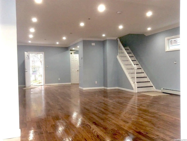 unfurnished living room featuring wood-type flooring and baseboard heating