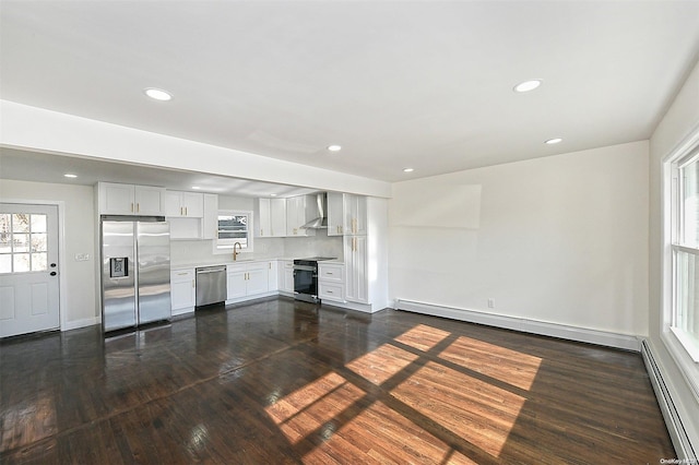 unfurnished living room featuring dark hardwood / wood-style flooring, a baseboard radiator, and sink