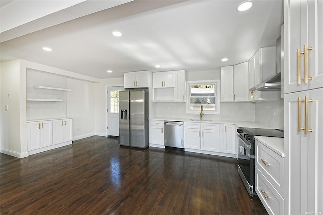 kitchen featuring plenty of natural light, dark hardwood / wood-style flooring, white cabinetry, and stainless steel appliances