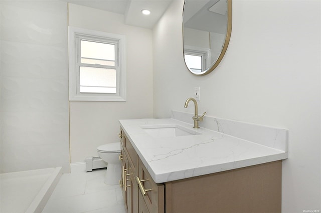 bathroom featuring tile patterned flooring, vanity, toilet, and baseboard heating