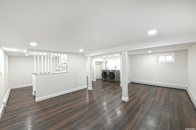 basement with washer and dryer, dark hardwood / wood-style floors, and a baseboard radiator