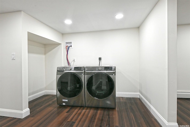 washroom with washer and dryer, dark hardwood / wood-style floors, and baseboard heating