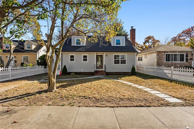 cape cod house with a front yard