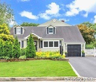 view of front facade with a front lawn and a garage