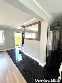 interior space featuring dark hardwood / wood-style floors and ornamental molding