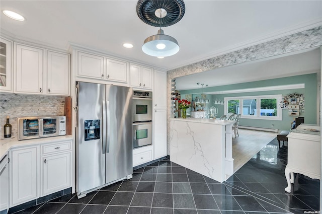 kitchen featuring white cabinetry, crown molding, stainless steel appliances, and a baseboard radiator