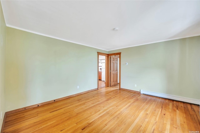 unfurnished room with a baseboard radiator, light hardwood / wood-style flooring, and crown molding