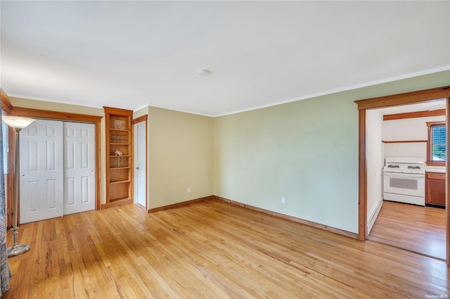 unfurnished bedroom with ornamental molding and light wood-type flooring