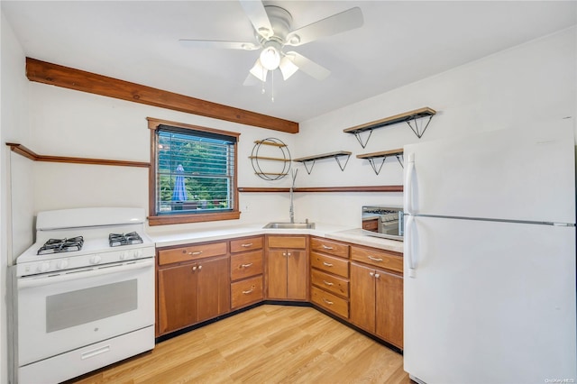 kitchen featuring light wood-type flooring, white appliances, ceiling fan, and sink