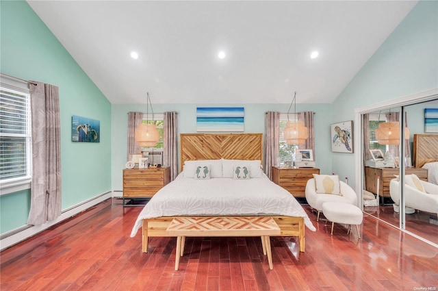 bedroom with hardwood / wood-style flooring, a baseboard radiator, and multiple windows