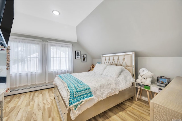 bedroom featuring vaulted ceiling, light hardwood / wood-style flooring, and a baseboard heating unit