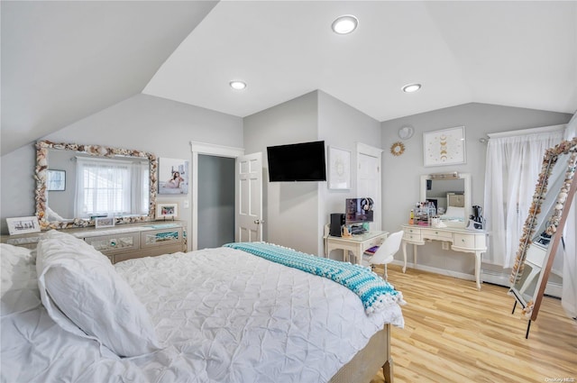 bedroom featuring light hardwood / wood-style floors and vaulted ceiling