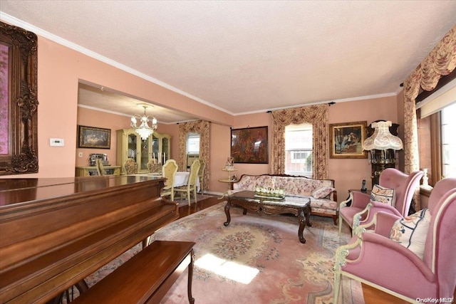 living room featuring hardwood / wood-style floors, a notable chandelier, ornamental molding, and a textured ceiling