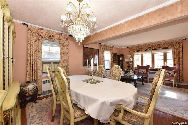 dining room with crown molding, plenty of natural light, and hardwood / wood-style flooring