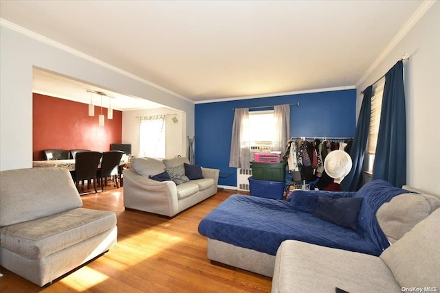 living room with crown molding, plenty of natural light, and wood-type flooring