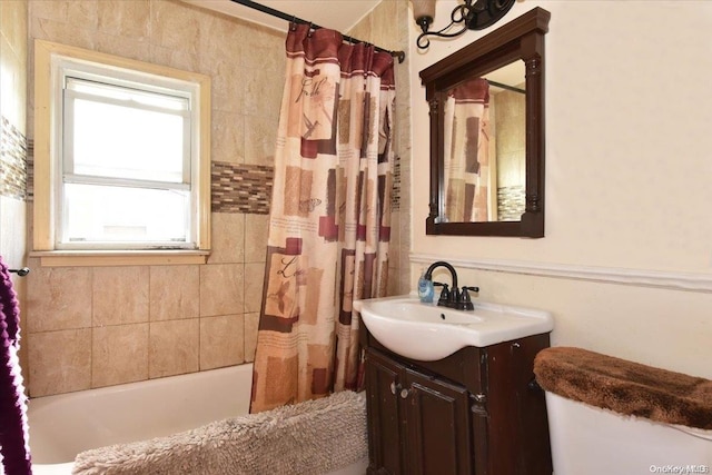 full bathroom with vanity, shower / bathtub combination with curtain, and toilet