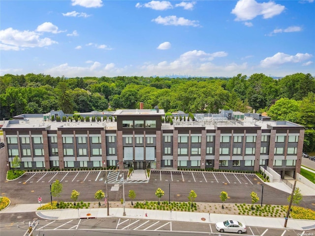 218 Middle Neck Rd Unit 301, Great Neck, NY 11021 - view of property featuring uncovered parking and a wooded view