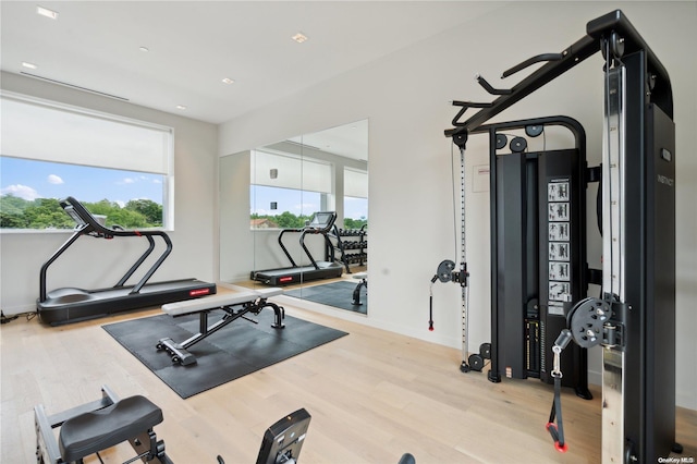 workout room with light hardwood / wood-style flooring