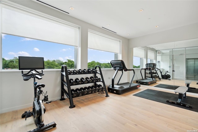 gym with light hardwood / wood-style flooring