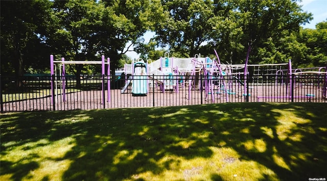 view of pool with a lawn and a playground