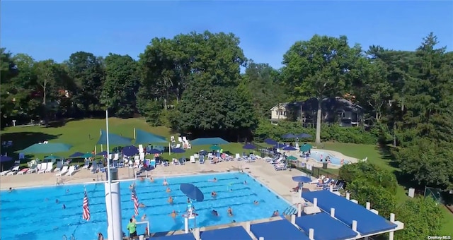 view of pool with a patio and a water view