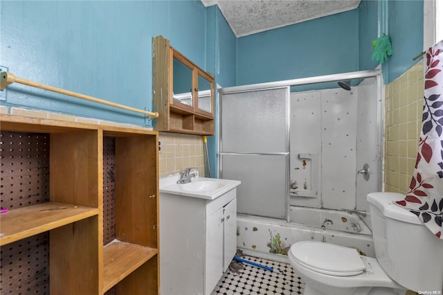 full bathroom with tile walls, vanity, bathtub / shower combination, and toilet