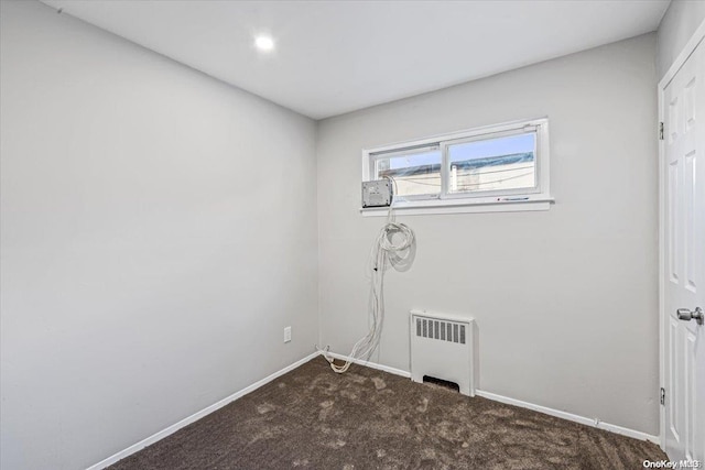 laundry room featuring carpet and radiator