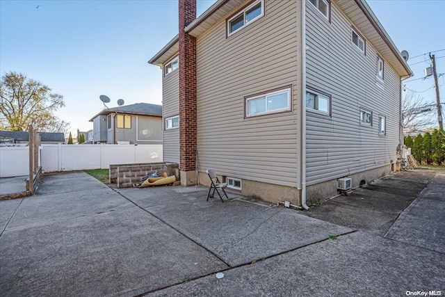 view of property exterior with a patio area