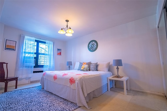 bedroom featuring a chandelier and light carpet