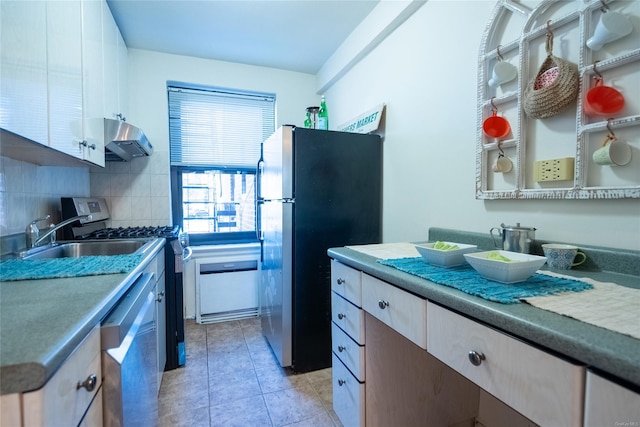 kitchen featuring white cabinetry, sink, ventilation hood, backsplash, and appliances with stainless steel finishes