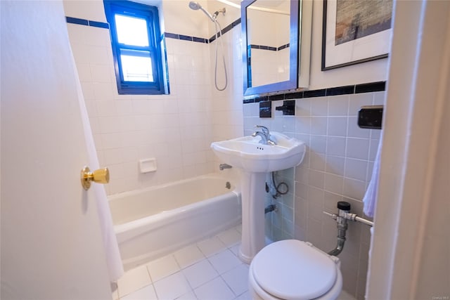 bathroom featuring shower / bath combo with shower curtain, tile patterned flooring, tile walls, and toilet