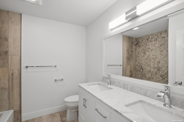 bathroom with hardwood / wood-style floors, vanity, and toilet