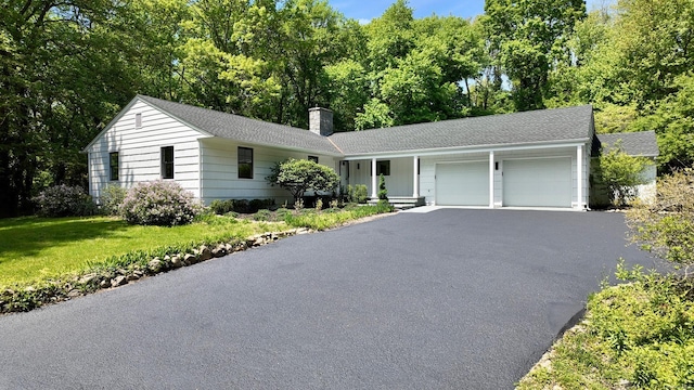 471A Woodbury Rd Unit A, Cold Spring Harbor, NY 11724 - ranch-style home with an attached garage, a chimney, driveway, and a front lawn