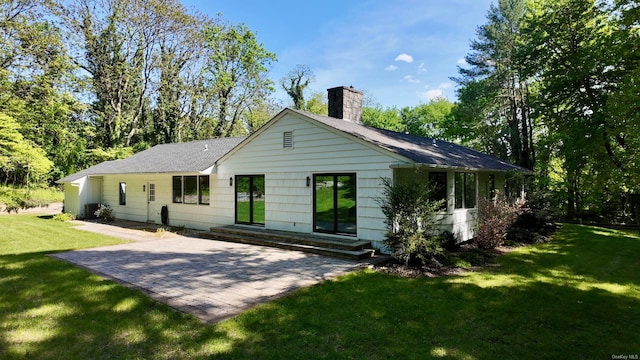 471A Woodbury Rd Unit A, Cold Spring Harbor, NY 11724 - back of property featuring a chimney, a lawn, a patio, and roof with shingles