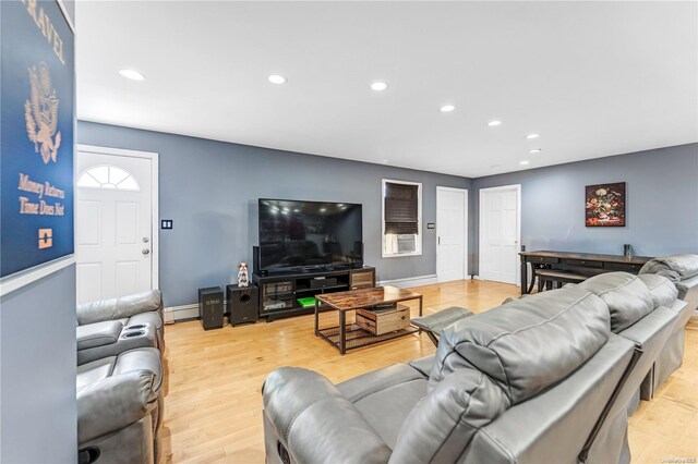 living room featuring baseboard heating and light hardwood / wood-style flooring