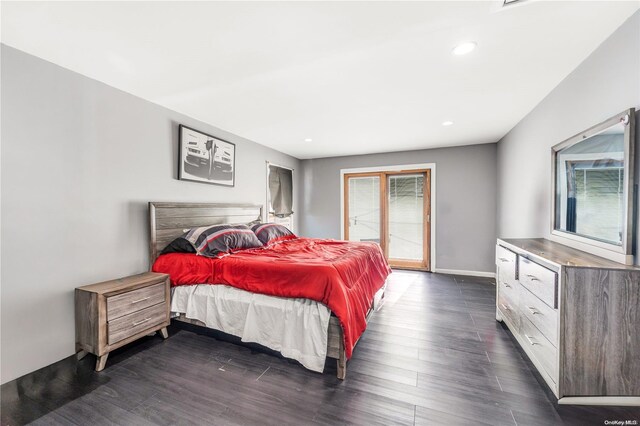 bedroom with dark hardwood / wood-style flooring