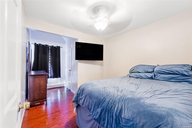 bedroom featuring ceiling fan and dark hardwood / wood-style flooring