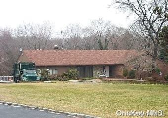 ranch-style home featuring a front yard