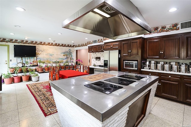 kitchen featuring island exhaust hood, appliances with stainless steel finishes, a center island, and dark brown cabinetry