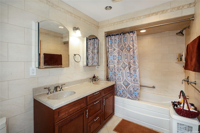 bathroom featuring tile patterned flooring, vanity, tile walls, and shower / bath combo with shower curtain