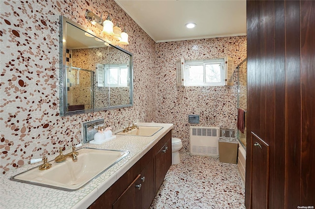 bathroom featuring radiator, a wealth of natural light, toilet, and ornamental molding